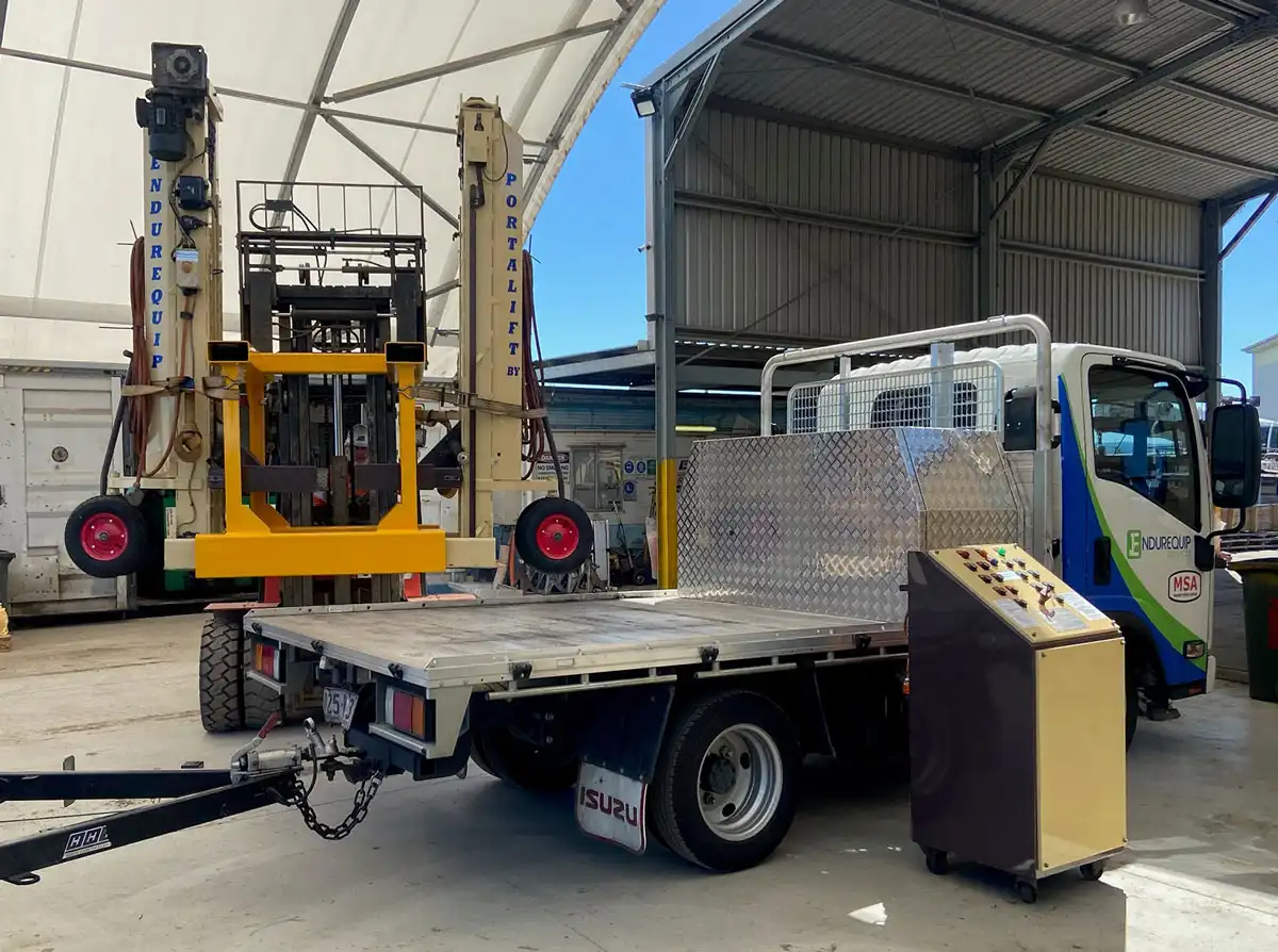 Unloading the heavy vehicle portable hoists from the truck ready for servicing trucks and vehicle, National Repairers Network.